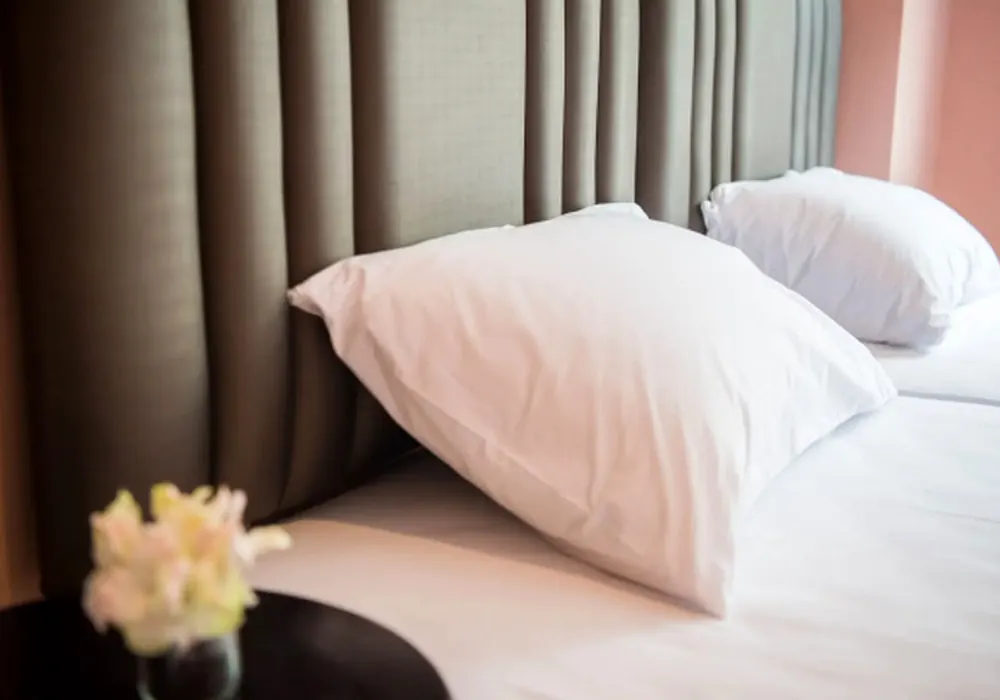Fresh white bedding in a Let's Zzz Bangkok guest room